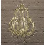 A four light chandelier formed from painted metalwork foliate scrolls and adorned with glass