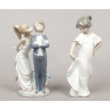 A Lladro porcelain figure group of a courting couple, along with Nao example of a young girl in a