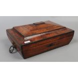 A Regency mahogany table box of sarcophagus form banded with coromandel with brass loop handles.