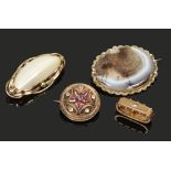 Three Victorian pinchbeck brooches including a moss agate example along with a scarf clip set with a