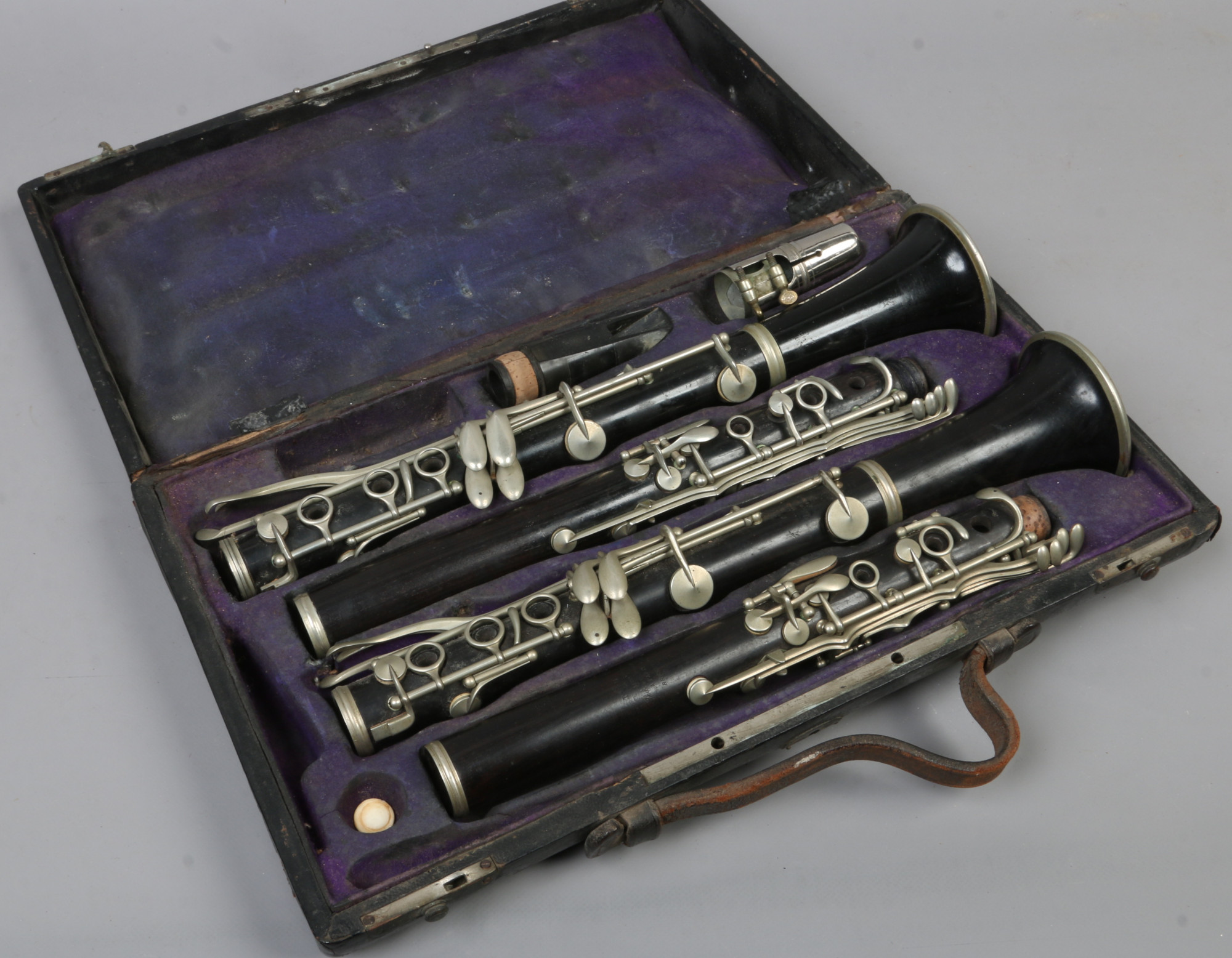 A cased set of two French ebonised clarinets one by Couesnon, the other by Martin Thibouville.