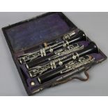 A cased set of two French ebonised clarinets one by Couesnon, the other by Martin Thibouville.