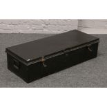 A black painted twin handle tin trunk.