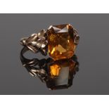 A Victorian gold dress ring set with a large rectangular cut citrine on floriform shoulders, size