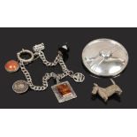 A silver charm bracelet with an amber charm and 3 pence coin, a silver Celtic brooch, London 1990