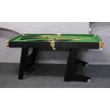 A B.C.E 6 foot folding pool table with cues.