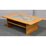 A hardwood two tier coffee table inset with a tile design.