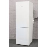 A Siemans white enamel tall standing electronic fridge freezer model KG36 VVW30G, 187cm high, 60cm