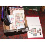 A collection of empty stamp albums, along with English stamp album and a tin of loose stamps to