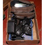 A collection of photographic equipment to include two Praktika MTL3 35mm SLR cameras, various lenses
