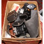 A box of photographic equipment to include disc cameras, Polaroid, box camera, lenses etc.