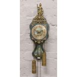 An ornate brass and hand painted wall clock.