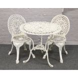 A painted cast aluminium circular garden table and two matching chairs.