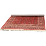 A red ground Bokhara rug 190cm x 135cm.