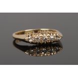 An 18ct gold five stone diamond ring in boat shaped setting. Set with five old European cut diamonds