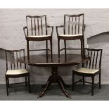 A Stag mahogany extending centre pedestal dining table and a set of four chairs to include two