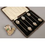 A cased set of six silver demitasse spoons with coffee bean terminals, along with a meerschaum