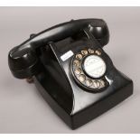 A vintage black Bakelite Telephone Rentals Limited Rotary telephone.