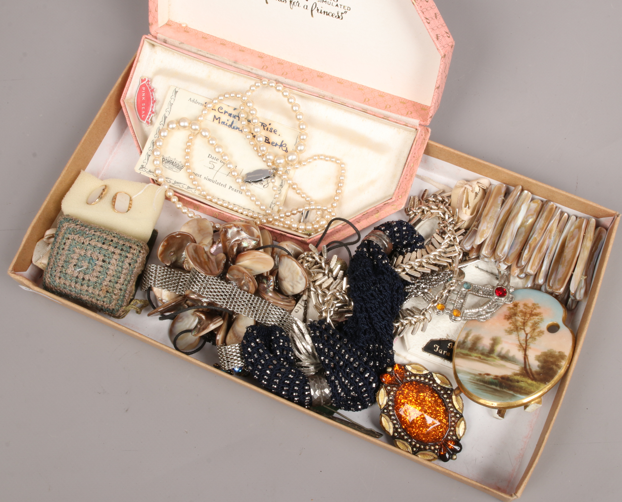 A box of costume jewellery to include simulated pearls, bracelets, brooches, cufflinks etc.