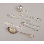 A quantity of silver flatwares including a George III caddy spoon, sugar tongues etc, total weight