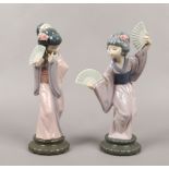 Two Lladro Japanese geisha girl figures with fans.