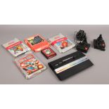 A Retro Atari 2600 gaming console along with two oriental joysticks, power supply and five games