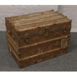 A vintage wooden metal bound travel trunk.