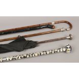 A bundle of mostly walking sticks including silver topped examples, a mother of pearl effect