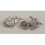 Two silver and marcasite studded rose brooches.