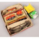 A Brimtoy tin plate train set to include carriages, track, building etc, along with a Tonka tin