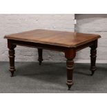 A Victorian mahogany wind out dining table raised on turned and reeded supports.