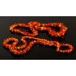 Two strings of irregular amber beads.