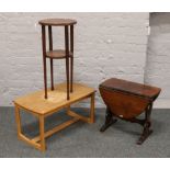 Three pieces of occasional furniture; on oval oak drop leaf side table, pine table and a two tier