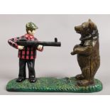 A novelty painted cast iron mechanical money box, formed as a hunter and bear.