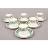 A set of six coffee cups and saucers decorated with blue swags and roses.Condition report intended