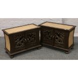 A pair of Indonesian carved hardwood cabinets with rattan top and sides raised on turned bun feet.