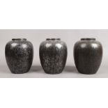 Three Poole black lustre vases, 22cm high 15cm diameter.