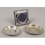 Two silver pin dishes with coin base along with a small silver picture frame, assayed London 2007 by