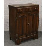 An oak side cabinet with linen fold decoration.