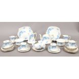 A Royal Stafford part tea service in the Wisteria design to include teapot, cups and saucers, milk