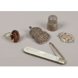 A collection of silver items to include silver and mother of pearl fruit knife, A.R.P badge,