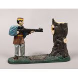 A novelty painted cast iron mechanical money box, formed as a soldier shooting at a tree trunk.