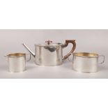 A three piece silver plate teaset to include teapot, twin handle sugar pot and cream jug.