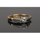 An 18ct gold and platinum diamond solitaire ring, stone approximately 0.128ct size J.