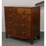 A Victorian carved oak chest of two over three graduated drawers raised on bracket feet (Height