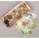 A small collection of vintage foreign bank notes and coins.