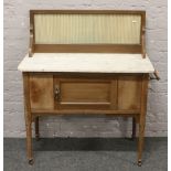 A Victorian oak marble top wash stand.