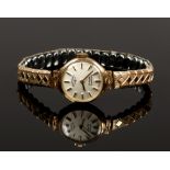 A ladies 9ct gold Rotary manual watch head with baton markers on gold plated expanding bracelet