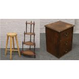 An early 20th century oak chest of three drawers, along with a turned wood bar stool and a what