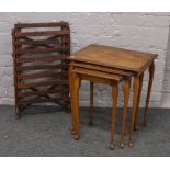 A nest of three figured walnut tables raised on cabriole legs, along with a wooden luggage rack.